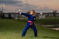 Kid boy practicing martial arts outdoor. Sport karate kids. Little boy wearing kimono doing karate in park. Child Royalty Free Stock Photo