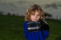 Kid boy practicing martial arts outdoor. Sport martial arts kids. Little boy wearing kimono doing karate in park. Child Royalty Free Stock Photo