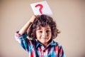 Kid boy with question mark. Children, education and emotions concept Royalty Free Stock Photo