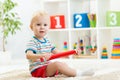 Kid boy sitting with big red pencil Royalty Free Stock Photo