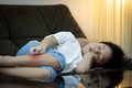 Kid boy is sleeping during the day at home,child using hand to scratch legs,itchy rash,red spot to mosquitoes bites or insect Royalty Free Stock Photo