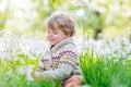 Kid boy in spring garden with blooming flowers Royalty Free Stock Photo