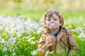 Kid boy in spring garden with blooming flowers Royalty Free Stock Photo