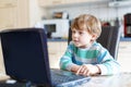 Kid boy surfing internet and playing on computer Royalty Free Stock Photo