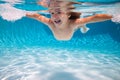 Kid boy swim underwater in pool. Child swimming and diving underwater in water pool. Underwater kids activity