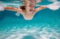 Kid boy swim underwater in pool. Child swimming and diving underwater in water pool. Underwater kids activity Royalty Free Stock Photo