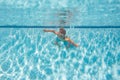 Kid boy swim underwater in sea. Kid swimming in pool under water. Active kid swimming, playing and diving, children Royalty Free Stock Photo