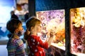 Kid boy and toddler girl visiting together zoo aquarium. Two children watching fishes, corals and jellyfishes. School Royalty Free Stock Photo