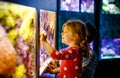 Kid boy and toddler girl visiting together zoo aquarium. Two children watching fishes, corals and jellyfishes. School Royalty Free Stock Photo