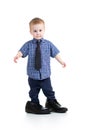 Kid boy trying on father shoes Royalty Free Stock Photo