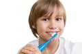 Kid brushing his teeth with toothbrush isolated on white backgroun