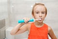 Kid brushing teeth with electic brush in bathroom. Dental hygiene every day. Happy boy cleaning teeth Royalty Free Stock Photo