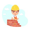 Kid builder working on building construction, cute worker boy in helmet holding trowel Royalty Free Stock Photo