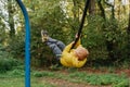 Kid Bungee jumping in the Autumn Forest. Royalty Free Stock Photo