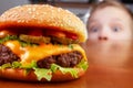 Kid and burger Royalty Free Stock Photo