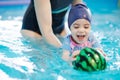 Kid catch ball on swim lesson Royalty Free Stock Photo