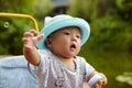 Kid catching soap bubbles Royalty Free Stock Photo