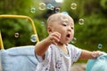 Kid catching soap bubbles Royalty Free Stock Photo