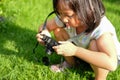 Kid, Child, Asian little girl holding and looking at the digital camera, learn how to take a photo Royalty Free Stock Photo