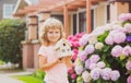 Kid child dreaming of new home. Happy boy holding dream house in their hands, real estate and home insurance concept. Royalty Free Stock Photo