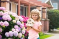 Kid child dreaming of new home. Happy boy holding dream house in their hands, real estate and home insurance concept. Royalty Free Stock Photo