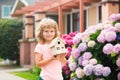 Kid child dreaming of new home. Happy boy holding dream house in their hands, real estate and home insurance concept. Royalty Free Stock Photo