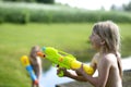 Girl playing with water gun toy in the summer Royalty Free Stock Photo