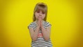 Kid child girl praying, making wish, asking with hopeful imploring expression, begging apology Royalty Free Stock Photo