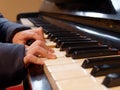 Kid or child hands playing piano closeup