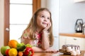 Kid choosing between healthy vegetables and tasty Royalty Free Stock Photo