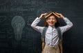 Kid in class on background of blackboard