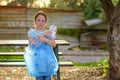 Kid cleaning in park.Volunteer child with a garbage bag cleaning up litter, putting plastic bottle in recycling bag. Royalty Free Stock Photo