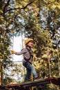 Kid climbing trees in park. Beautiful little child climbing and having fun in adventure Park. Safe Climbing extreme Royalty Free Stock Photo