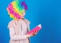 Kid colorful curly wig artificial hair clown style hold book. Reading jokes. Time to have fun. Circus school. Study hard