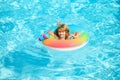 Kid with colorful floating ring. Child in swimming pool. Summer holiday. Kids water toys. Little boy swim. Child water Royalty Free Stock Photo