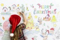 Kid coloring a Christmas drawing Royalty Free Stock Photo