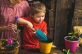 Kid concept. Kid learn planting flower in pot with soil. Little kid potting plants. Adorable kid with gardening tools Royalty Free Stock Photo