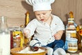 The kid the cook cooks food in kitchen Royalty Free Stock Photo