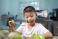 Kid cute boy eating healthy food in at home. Royalty Free Stock Photo