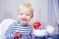 Kid cute boy sit at table with plate and food. Healthy food. Boy cute baby eating breakfast. Baby nutrition. Eat healthy Royalty Free Stock Photo