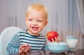 Kid cute boy sit at table with plate and food. Healthy food. Boy cute baby eating breakfast. Baby nutrition. Eat healthy Royalty Free Stock Photo