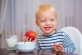 Kid cute boy sit at table with plate and food. Healthy food. Boy cute baby eating breakfast. Baby nutrition. Eat healthy Royalty Free Stock Photo