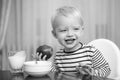 Kid cute boy sit at table with plate and food. Healthy food. Boy cute baby eating breakfast. Baby nutrition. Eat healthy Royalty Free Stock Photo