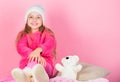 Kid cute girl play with soft toy teddy bear pink background. Teddy bears improve psychological wellbeing. Child small