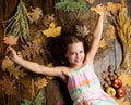 Kid cute girl relax wooden background autumn attributes top view. Child long hair with dry leaves. Tips for turning