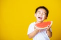 Kid cute little boy attractive laugh smile playing holds cut watermelon fresh for eating
