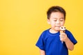 Kid cute little boy attractive laugh smile playing holds and eating sweet chocolate ice cream waffle cone Royalty Free Stock Photo