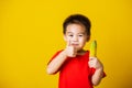 Kid cute little boy attractive smile playing holds bananas and show finger thumb for good sign Royalty Free Stock Photo