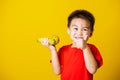 Kid cute little boy attractive smile playing holds bananas and show finger thumb for good sign Royalty Free Stock Photo