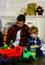 Kid and dad play lego toys. Father and son create toys from bricks. Dad and kid build of plastic blocks. Royalty Free Stock Photo